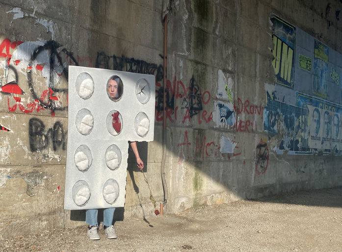 wearable sculpture, woman dressed as a pill blister pack