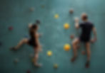 two climbers in a wall discuss the next steps