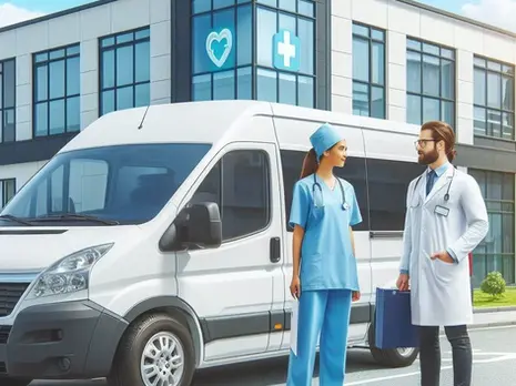 A female nurse talking with a male doctor next to a white van.