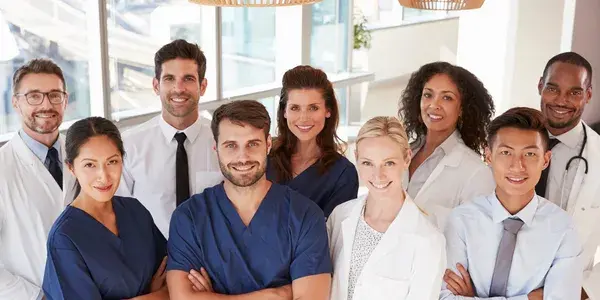 Group of hospital personel smiling at camera.