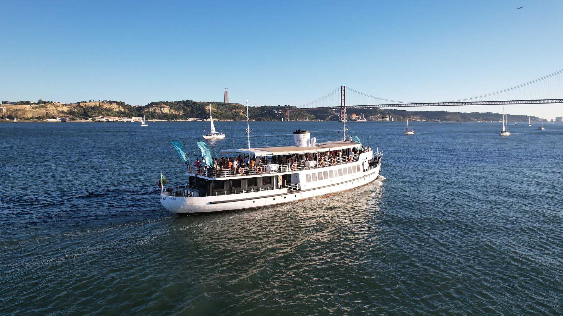 Royal Marine boat cruising on the Tagus River in Lisbon during a private Christmas dinner, with the 25th of April Bridge in the background.