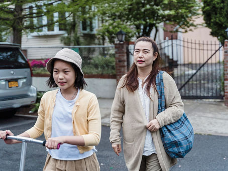 Mother and daughter walking together as the child leads the way