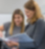 Two Signature Performance team members reviewing an onboarding guidebook together