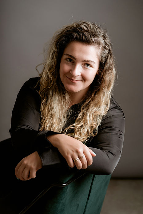 Erin, the founder, sitting smiling at the camera