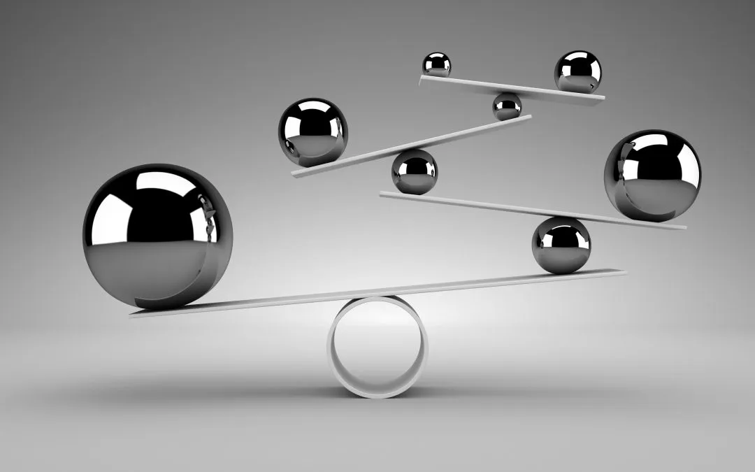 An image of orbs balanced on platforms in black and white