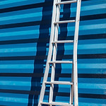 Ladder Against Blue Wall