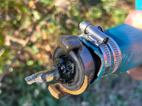 Detailed view of a Gardena-style hose connector showing signs of freezing and cold weather exposure.