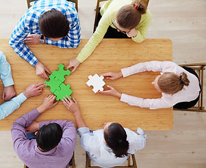 077440737-people-assembling-jigsaw-puzzl