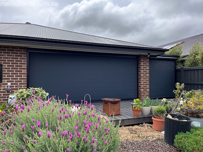 Outdoor ziptrak blinds rom Malibu Blinds on a brick house.
