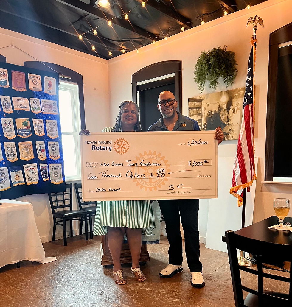 Pam Jones accepts a ceremonial $1,000 grant check from a representative of Flower Mound Rotary during a grant presentation benefiting the Alice Givens Jones Foundation.
