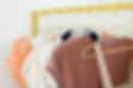 Assorted shirts hanging on a gold rack