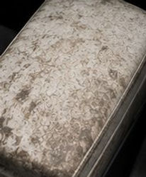 Heavily stained car center console armrest before cleaning