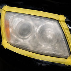 Cloudy car headlight taped for restoration service