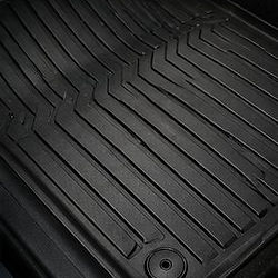 Clean black rubber car floor mat in a vehicle interior.