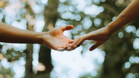 two hands reaching out to eachother