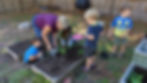 Children work with their teacher in the garden at Holistic Life Schools