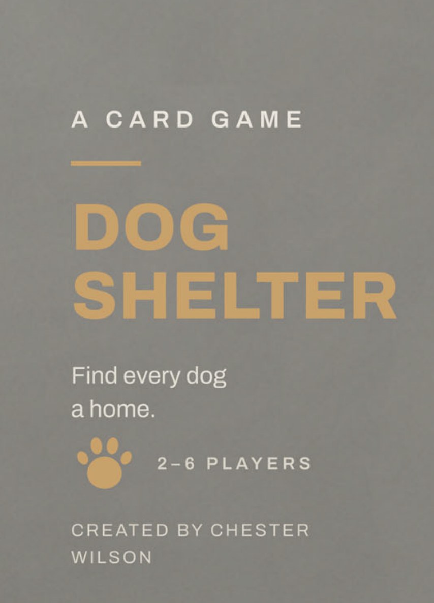 The Dog Shelter card game box: a slate grey tuck box with a gold paw print and the title Dog Shelter.