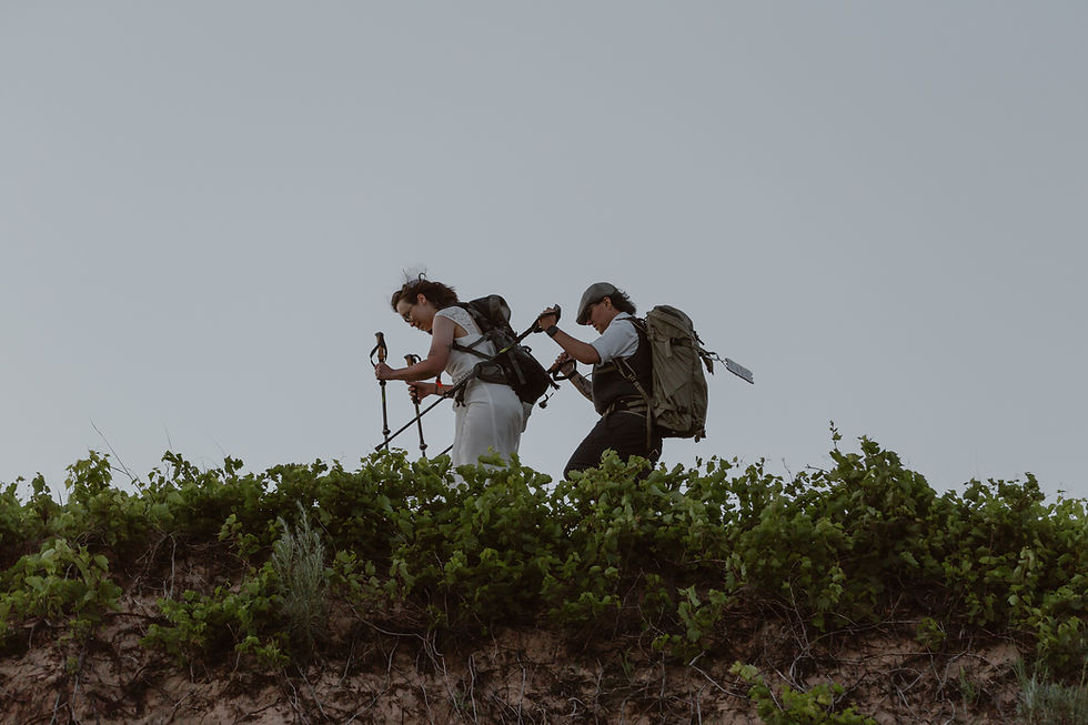 lesbian couple hiking on their elopement