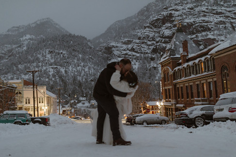 Bride and groom walking around Ouray Colorado, exploring and having a first dance on their snowmobile elopement day in Ouray Colorado