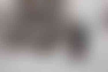 Bride helping the groom up after he fell down in the snow while they were snowshoeing on their elopement