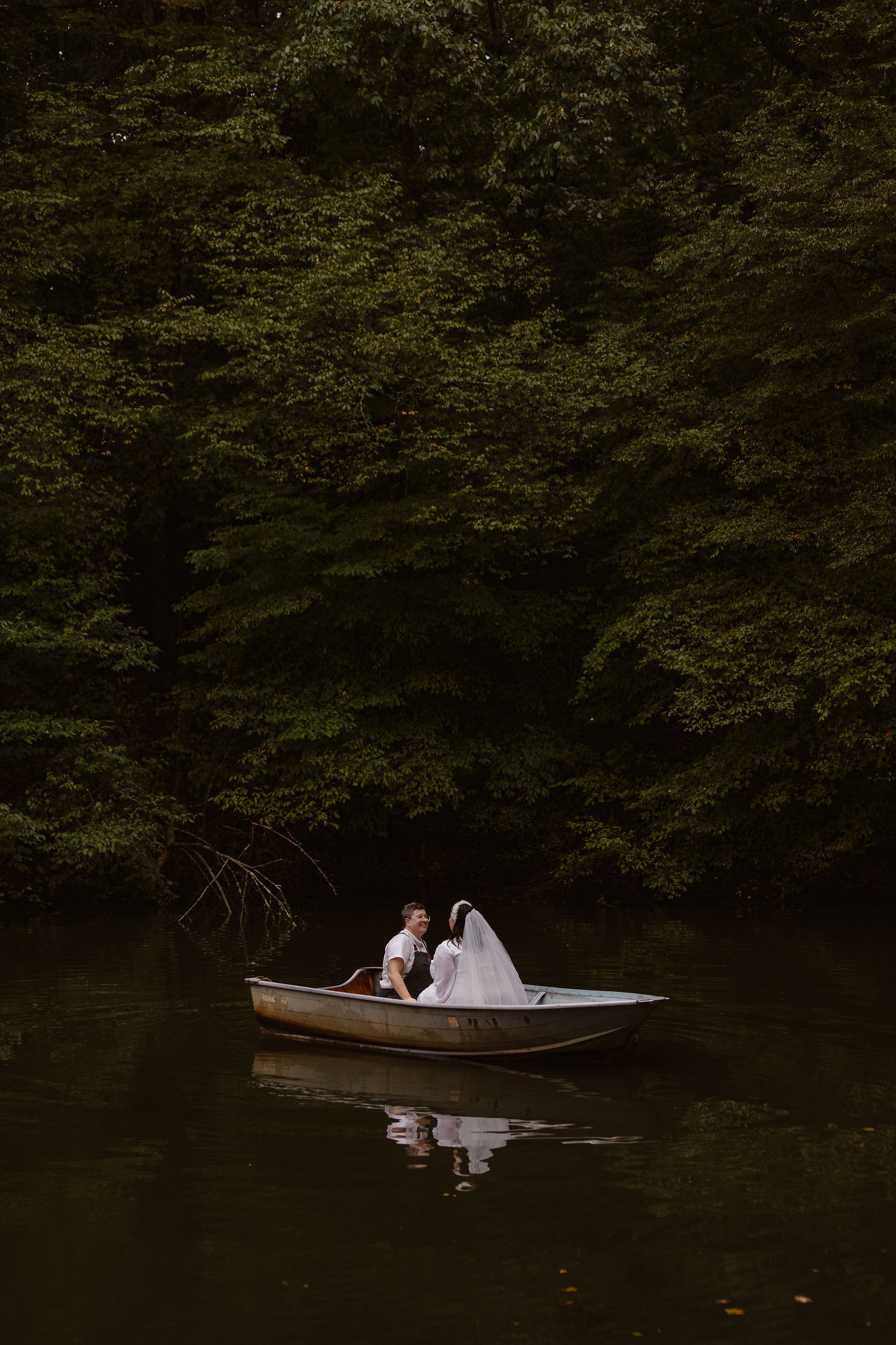couple canoeing on a pond in hocking hills in their hocking hills elopement