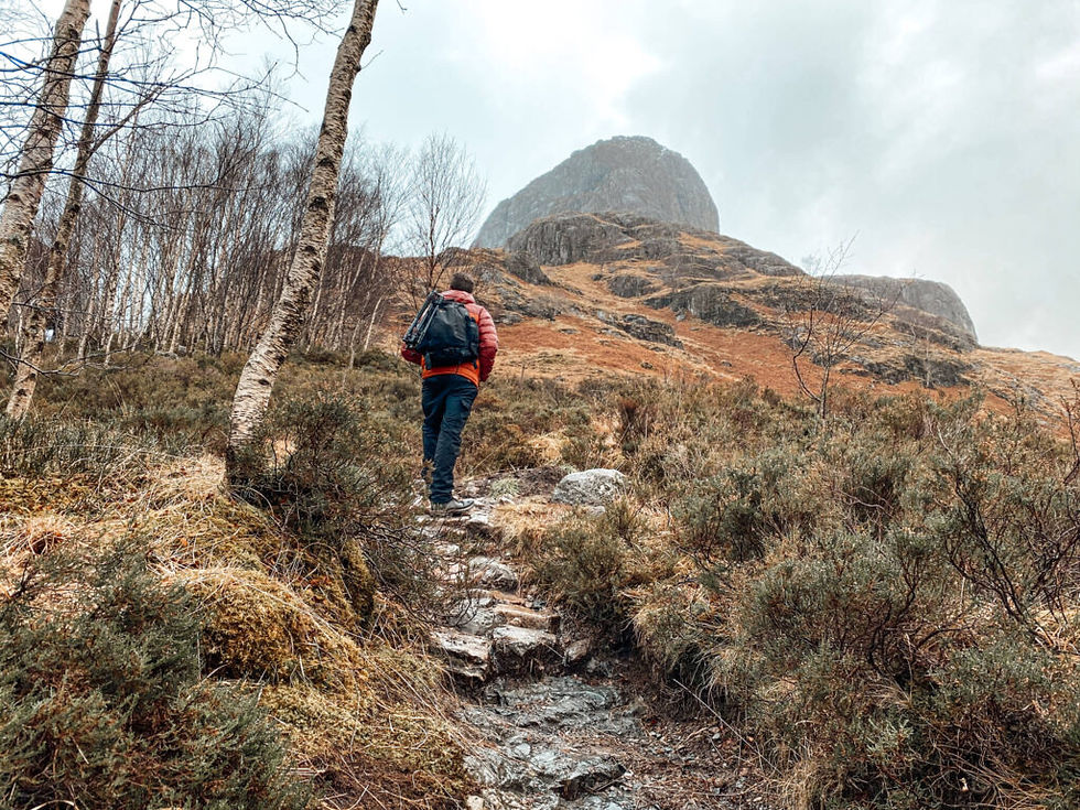 man walking towards mountains
