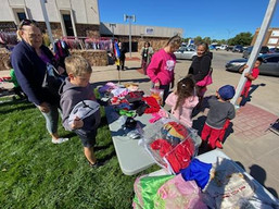 Kids collect costumes from the Hallowee costume drive