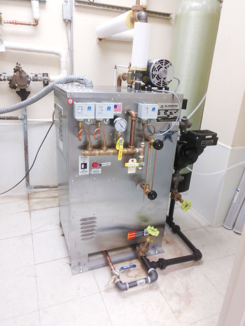 Medical sterilizer with gauges and piping to floor drain