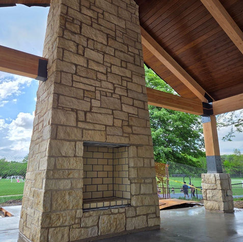 Stone fireplace in outdoor pavilion