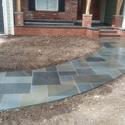 Curved bluestone walkway leading to home entrance