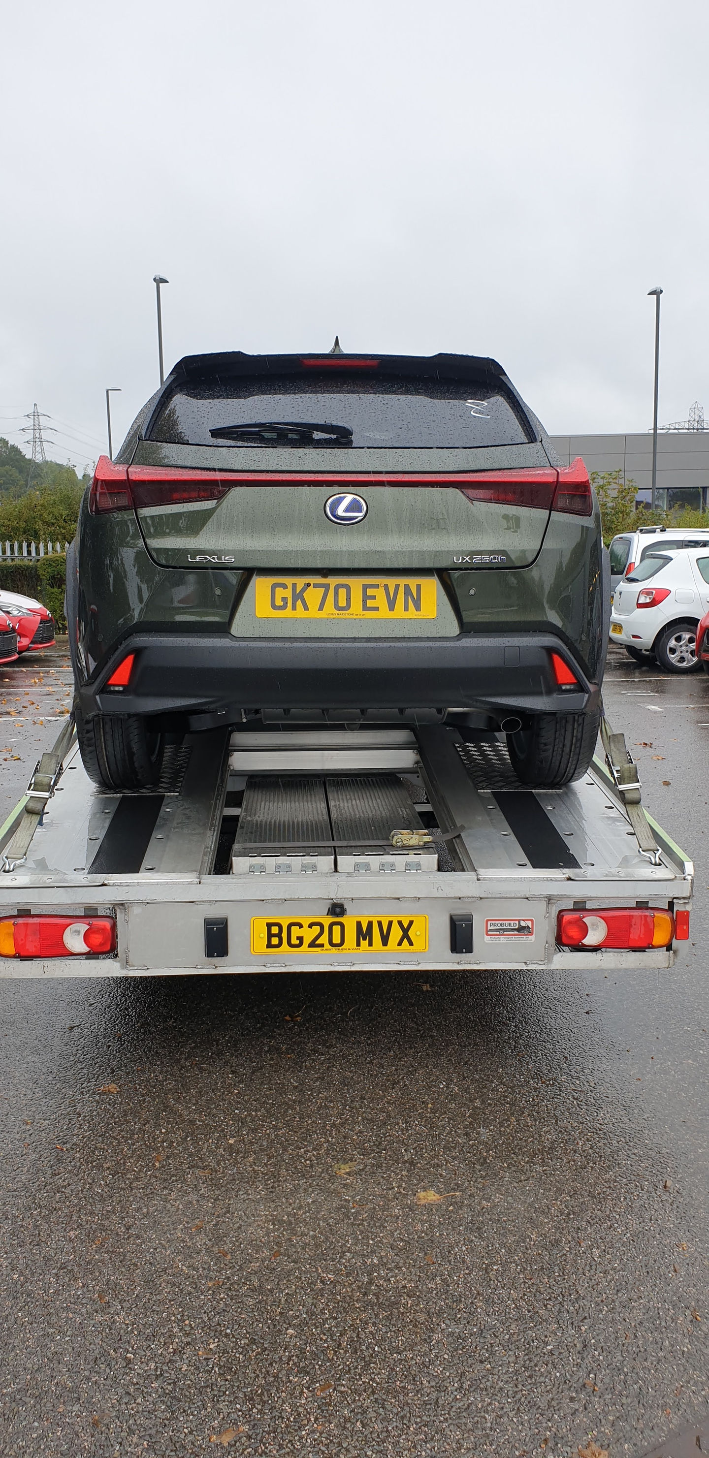 Green Lexus RX on car transporter, license plate CX70 LYR