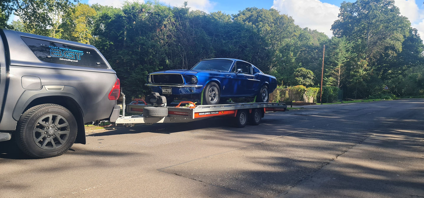 Blue classic Mustang on car transporter