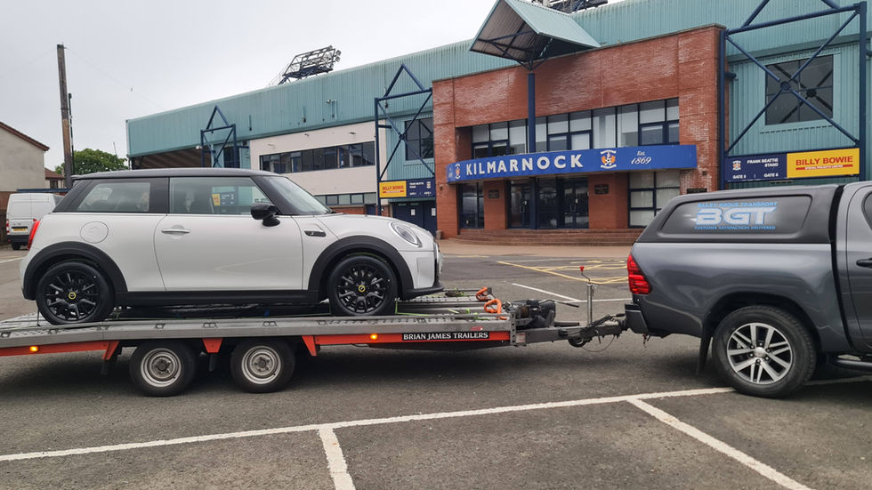 White Mini Cooper on car transporter