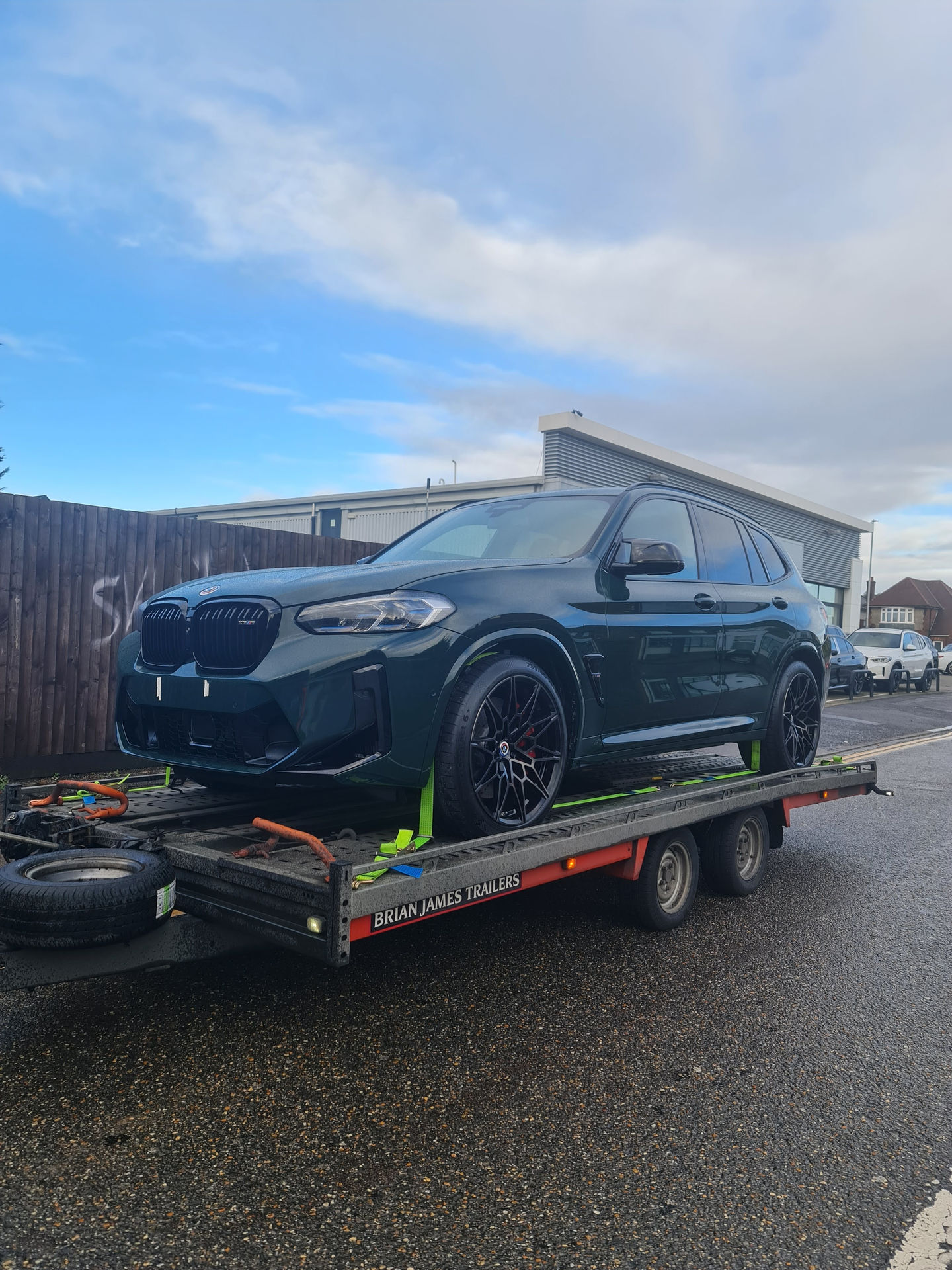 Green BMW X3 on car transporter
