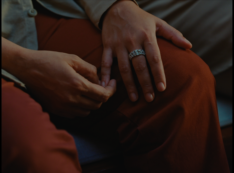Close-up of two people’s hands gently touching, conveying comfort and connection.