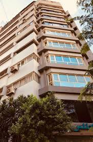 Spacious family room with two double beds, a seating area, and kid-friendly amenities.