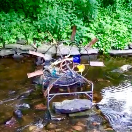 A sculptural wheel in a river