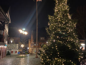 A quaint Black forest village is illuminated by a large traditional Christmas tree symbolizing presence and calm in the busy advent season