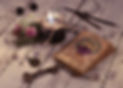 Black candle and old tarot cards on wooden planks. Halloween and fortune telling concept.