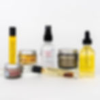 Deluxe Face Routine containing Lip Scrub, Awaken Facial Serum, Face Cream, Restoring Rose Tonic, Bright Eye Serum, Mud Mask, Facial Cleansing Oil glass bottles all shown together on white background
