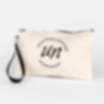 off white zippered pouch with unfiltered skin care logo printed in black, black zipper, black hand strap