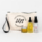 off white zippered pouch with unfiltered skin care logo, small glass bottles and jars of skincare products in front of bag