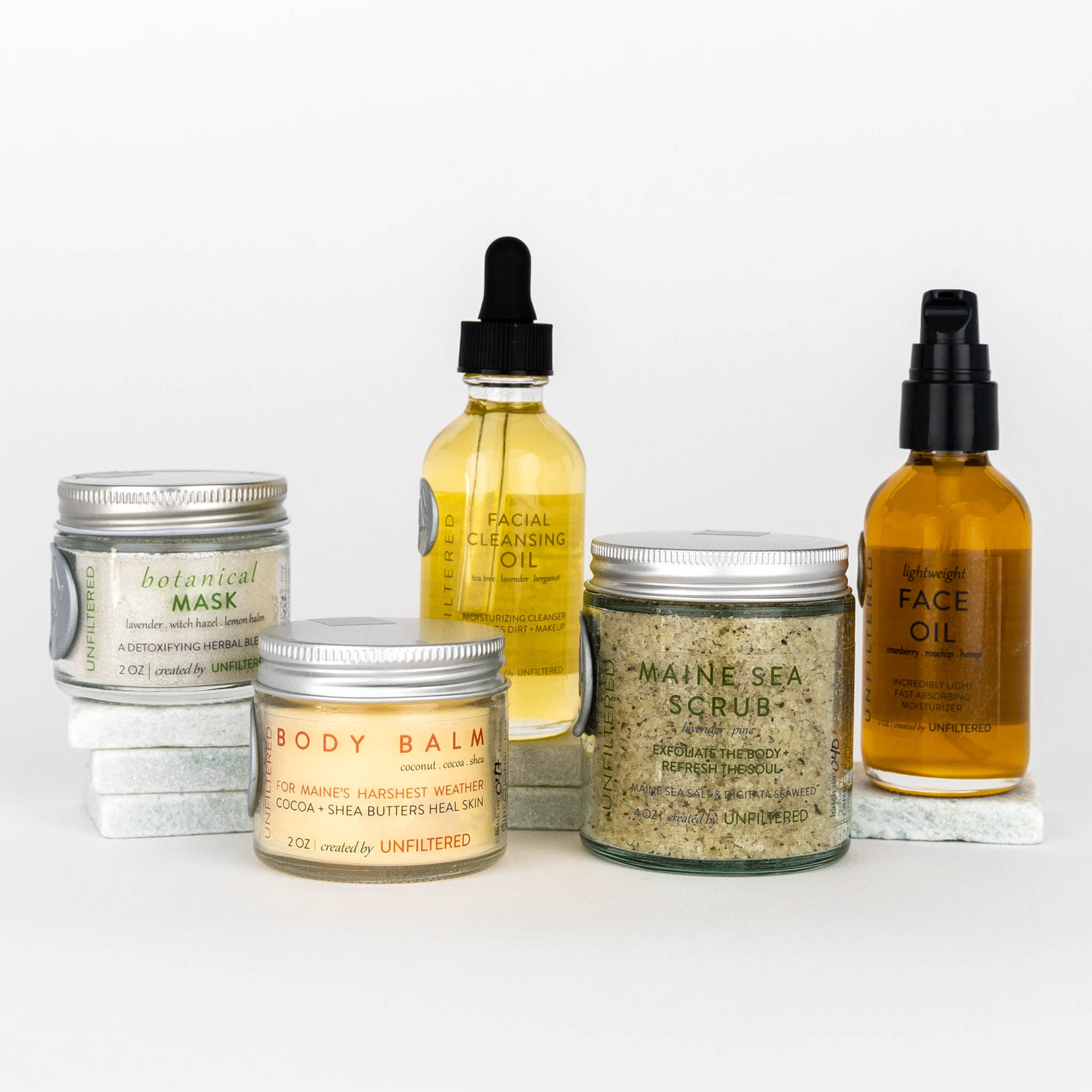Radiant Skin Face and Body Routine set featuring Botanical Mask, Body Balm, Facial Cleansing Oil, Maine Sea Scrub, and Lightweight Face Oil all shown together on white background