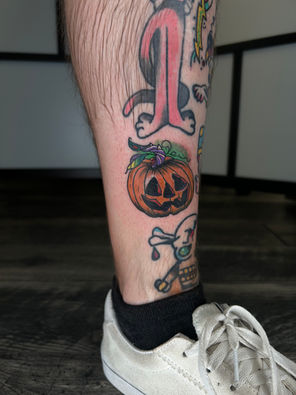 Color pumpkin tattoo on the leg. Halloween inspired tattoo. Rhode Island tattooer