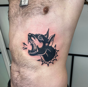 doberman tattoo. dog tattoo. traditional tattoo with black shading