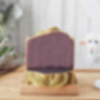 A dark bar of soap sitting on one laying flat.