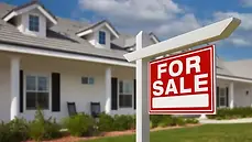 Home with a For Sale sign out front