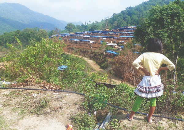 IDP girl looks out over IDP camp, built in the last several months