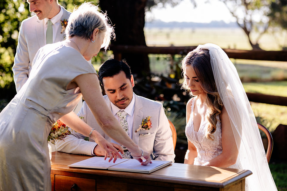Celebrant guides couple to sign a document