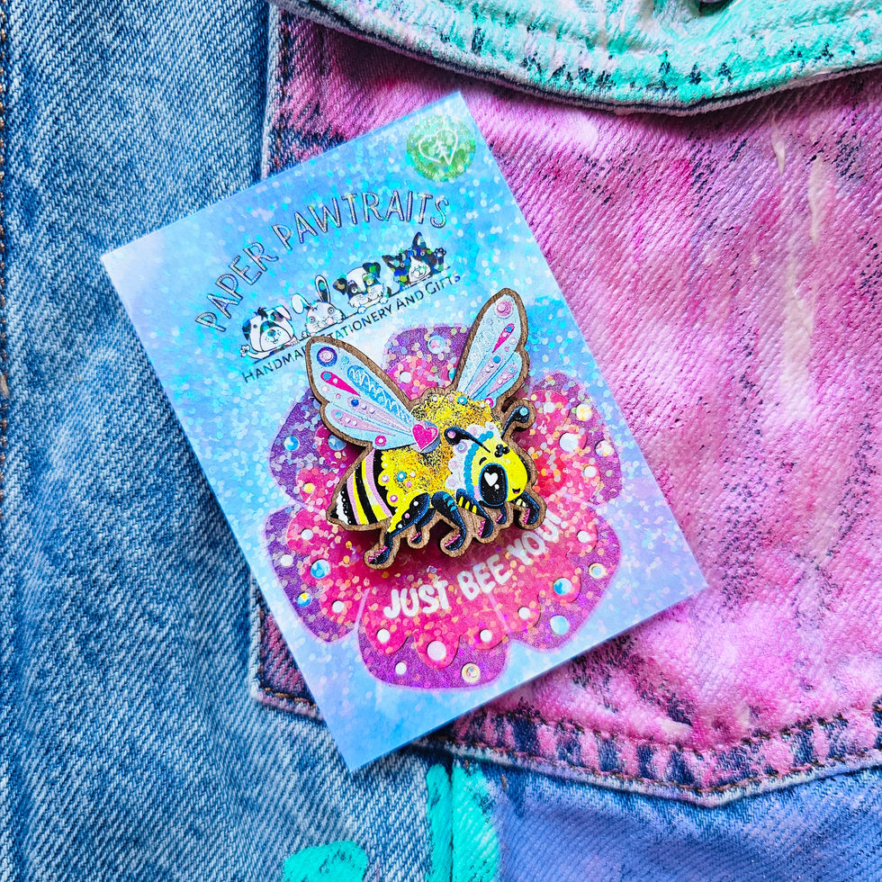 Nature-themed wooden bee pin with metal rubber clutch visible on reverse